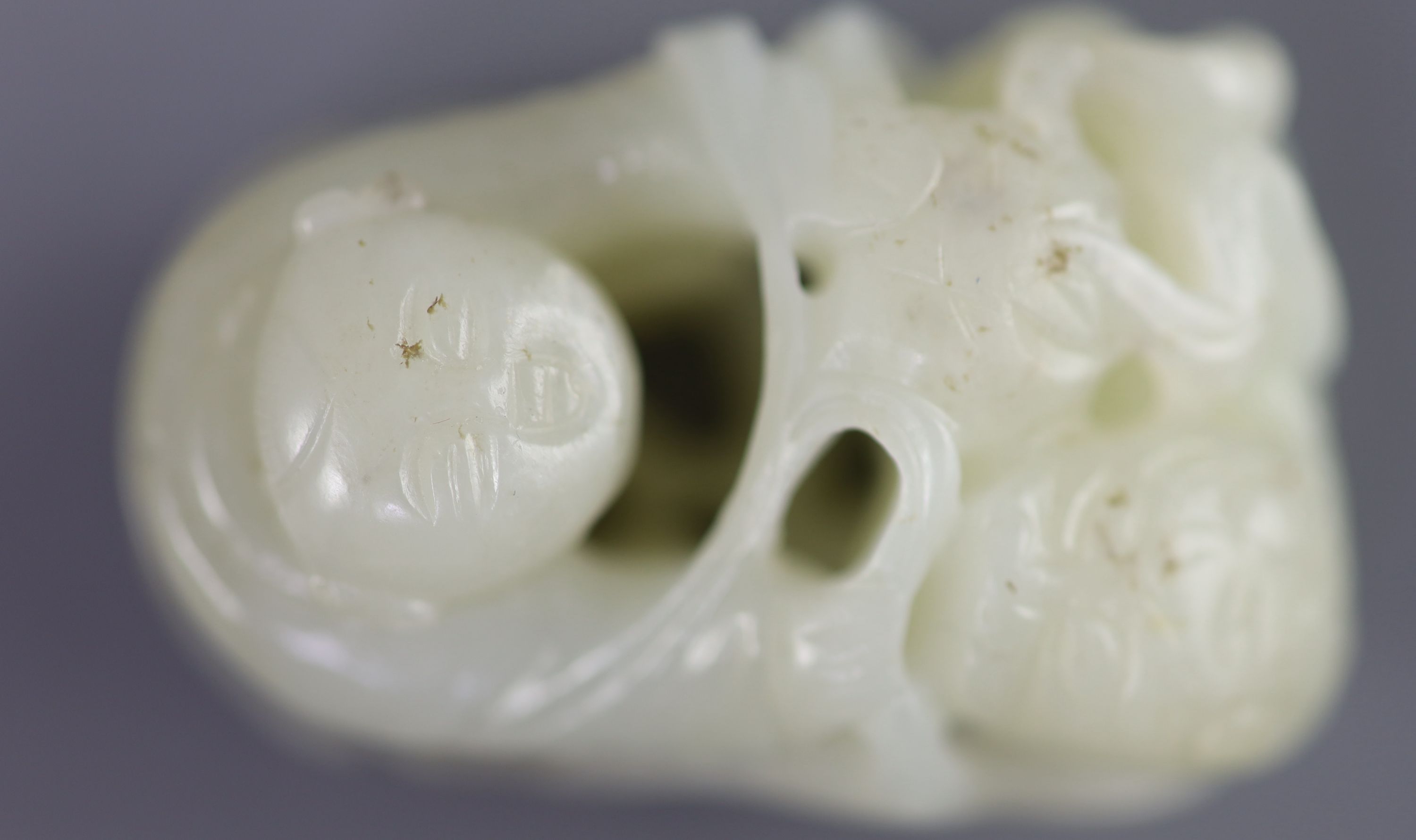 A Chinese pale celadon jade group of a boy and a lion-dog, 19th/20th century, 5.4cm